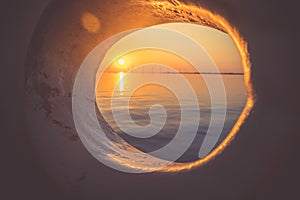 Warm summer evening sunlight with a view through the anchor hole on the ijsselmeer lake in the Netherlands