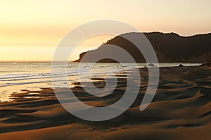 Warm sunset over the Pacific Ocean and the beach, a popular spot for surfers