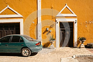 Warm texture shaby orange color wall background and green car.