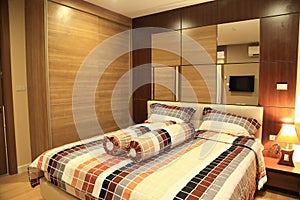 Warm tone of luxury interiors design of the bedroom in condominium.