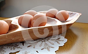 Warm-tone wood platter with fresh eggs