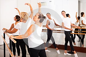 Warm-up sessions at bench, women doing ballet