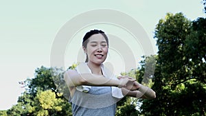 Warm-up, stretching, healthy, portrait of a happy Asian woman playing sports.
