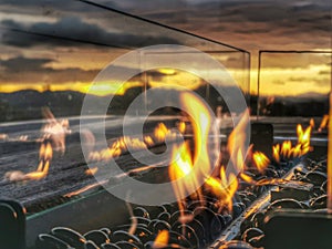 A warm welcome fire burning on a gas heater at sunset