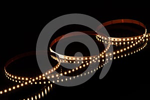 Warm white LED strip on black background photo