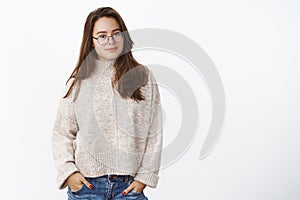 Warm winter days in cozy outfit. Portrait of charming smart and confident brunette in glasses wearing sweater, holding