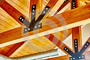 Warm Wooden Ceiling with Black Metal Brackets Detail