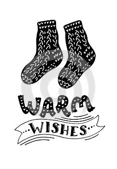 Warm woollen knitted sockes with lettering `Warm wishes`.