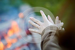 Warmed his hands at a fire