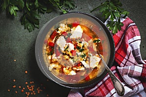 Warming autumn soup with red lentils, chicken fillet, vegetables, spices and paprika, comfort food. Green table, top view