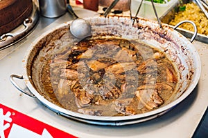 Warming braised pork belly in pan for Pork Belly Bun Gua Bao in street food market at Yuchi Township, Nantou County, Taiwan