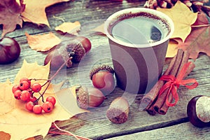 Warming coffee cup and autumn still life on table