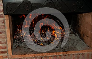 Warming a grill inside a chimney to make a barbecue