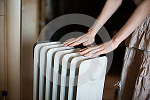 Warming his hands over a radiator.Warm battery.