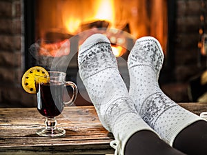 Warming and relaxing near fireplace with a cup of hot wine.