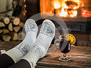 Warming and relaxing near fireplace with a cup of hot wine