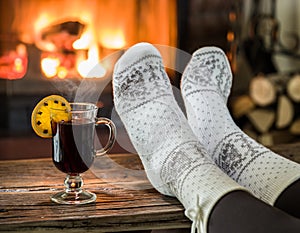 Warming and relaxing near fireplace with a cup of hot wine