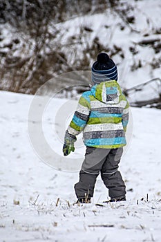 Warmly dressed boy standing in the snow