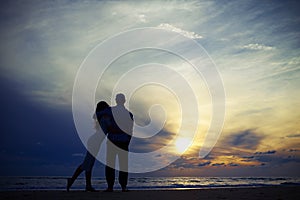 Warmth embracing of happy romantic couple in love on the beach a