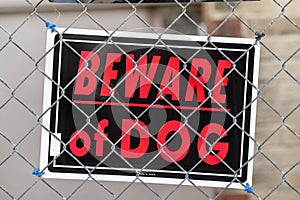 WARNING BEWARE OF DOG - sign on chain link fence
