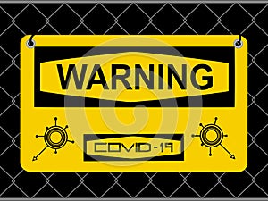 Warning Covid-19 yellow sign with logos on metallic fence net