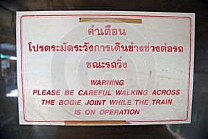 Warning information plate at Thailand railway station