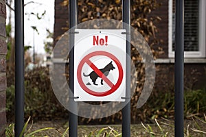 Warning label, No dog pooping sign in park for dog owners