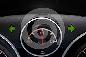 Warning light and fuel gauge on the dashboard of a car