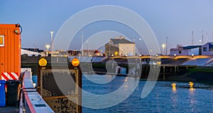 Warning lights on a board with the harbor of Blankenberge in the background, popular city in Belgium