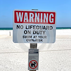 Warning No Lifeguard on Duty. Swim At Your Own Risk Sign.