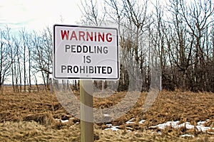 Warning peddling is prohibited sign