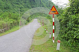 Warning road sign floods jungle mountains, Phong Nha, Vietnam