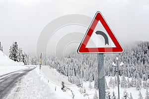 Warning Road Sign on a Snowy Mountain Road