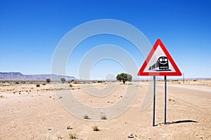 Warning of road sign - trains crossing the road