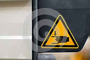 Warning sign on agricultural machinery. Do not put your hands out. Injury to hands is possible.