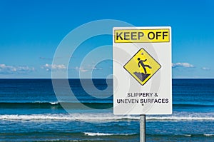 Warning sign with beach on the background