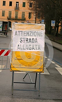 warning sign with big text ATTENZIONE STRADA ALLAGATA in italian language that means CAUTION FLOODED ROAD