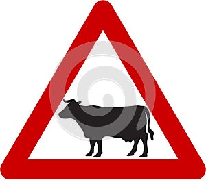 Warning sign with cattle on road