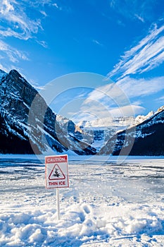 Warning sign `Caution thin ice` at Lake Louise
