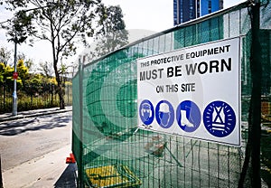 Warning sign construction site for must be worn this protective equipment on this site.