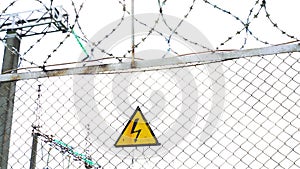 Warning sign about the danger of electricity. Sign on the fence of the power plant