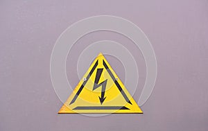 A warning sign of danger on a purple background.