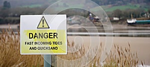 Warning sign - Danger - tides and quicksand, United Kingdom