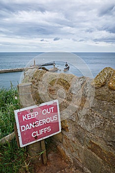 Warning sign , dangerous cliffs. Whitby, North Yorkshire.