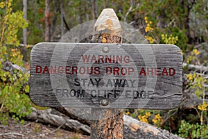 Warning sign dangerous drop ahead stay away from cliff edge