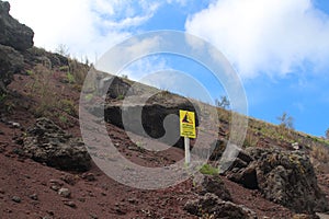 Warning sign from falling rocks at a mountain slope, Vesuvius, Italy