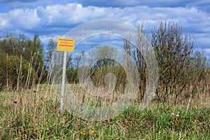 Warning sign in a field. It is forbidden to dig