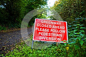 warning sign that the footpath is closed ahead pedestrians to follow a diversion