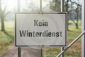 Warning sign with the German label `No winter service` at the entrance of a park
