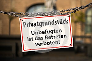Warning sign with german text: Privatgrundstueck - Unbefugten ist das Betreten verboten private property - no trespassing